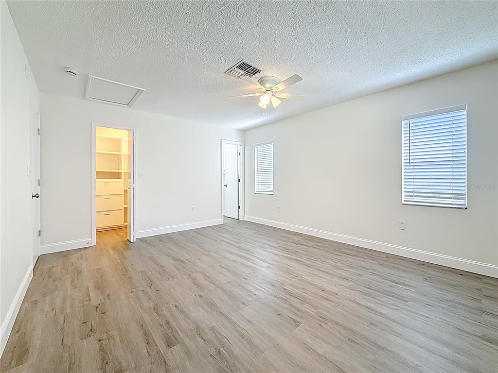 7480 118th Terrace Largo, FL 33773 - Photo 31 of 49 a view of empty room with wooden floor and fan