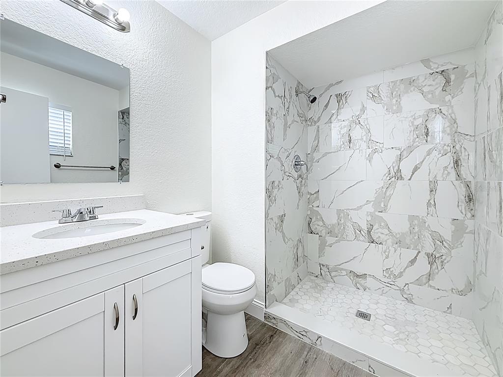 7480 118th Terrace Largo, FL 33773 - Photo 33 of 49 a bathroom with a sink toilet and shower