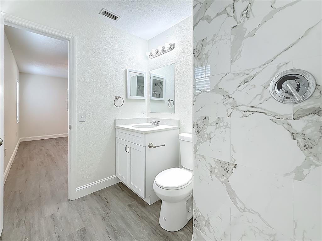 7480 118th Terrace Largo, FL 33773 - Photo 35 of 49 a bathroom with a toilet sink and a mirror