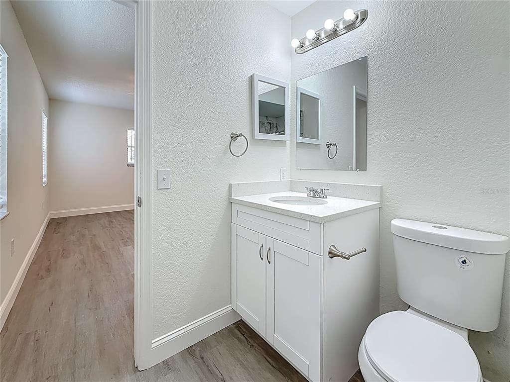 7480 118th Terrace Largo, FL 33773 - Photo 36 of 49 a bathroom with a toilet a sink and mirror