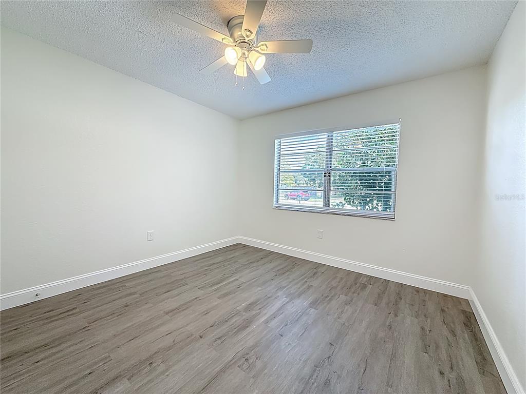 7480 118th Terrace Largo, FL 33773 - Photo 37 of 49 wooden floor in an empty room with a window