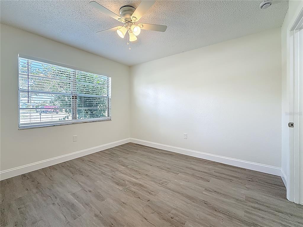 7480 118th Terrace Largo, FL 33773 - Photo 38 of 49 wooden floor in an empty room with a window