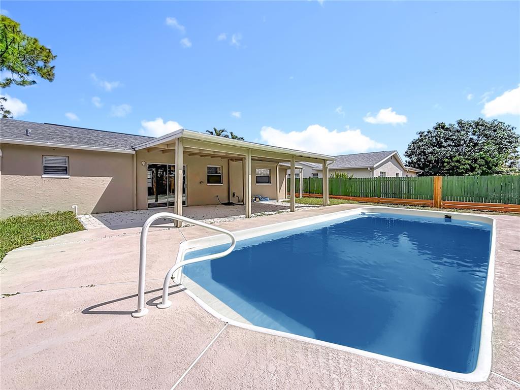 7480 118th Terrace Largo, FL 33773 - Photo 4 of 49 a view of a house with pool and a yard