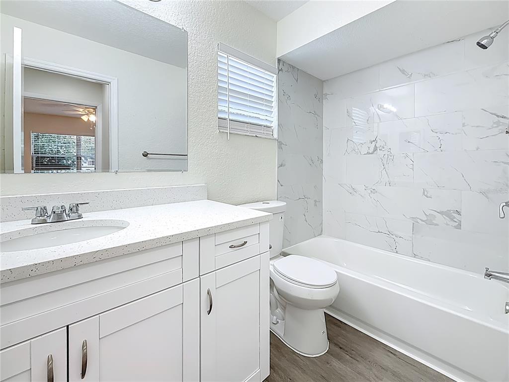 7480 118th Terrace Largo, FL 33773 - Photo 41 of 49 a bathroom with a sink a toilet and a bathtub