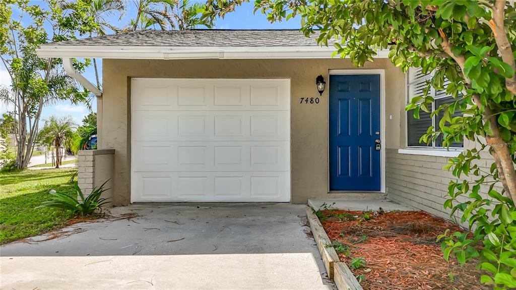 7480 118th Terrace Largo, FL 33773 - Photo 10 of 49 a front view of a house with a garden