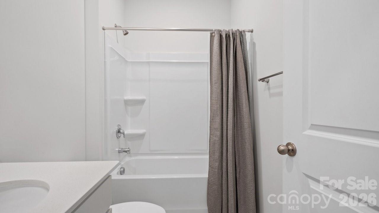 3688 Mercer Street Terrell, NC 28682 - Photo 24 of 34 a bathroom with a shower curtain and a sink