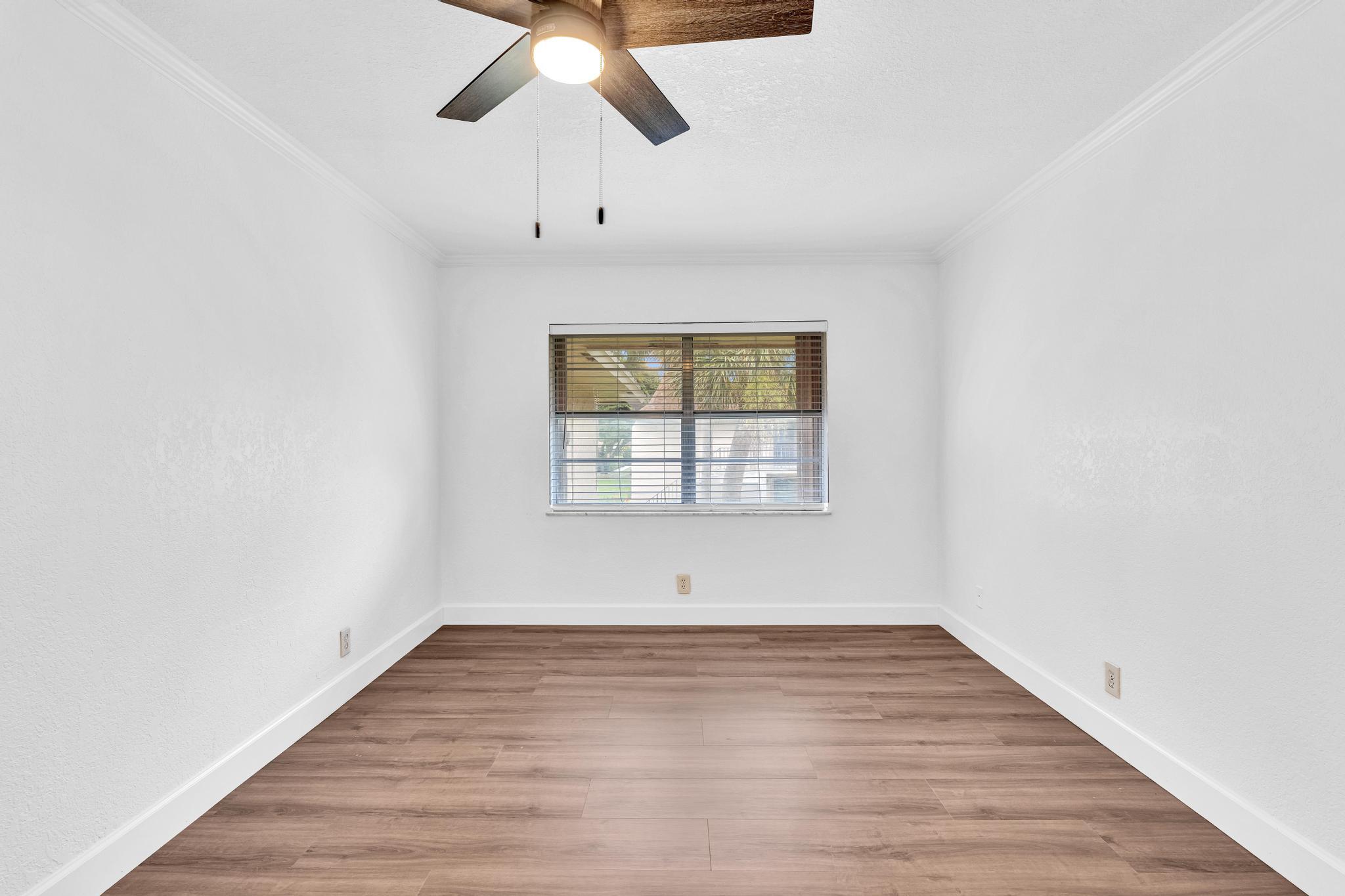 1291 Northwest 13th Street, Unit 445D Boca Raton, FL 33486 - Photo 31 of 50 wooden floor in an empty room with a window