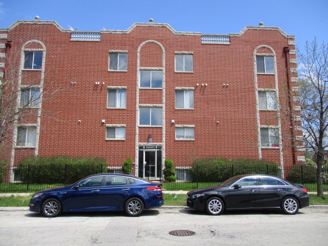 6655 South Perry Avenue, Unit 2C Chicago, IL 60621 - Photo 1 of 10 a cars parked in front of a building