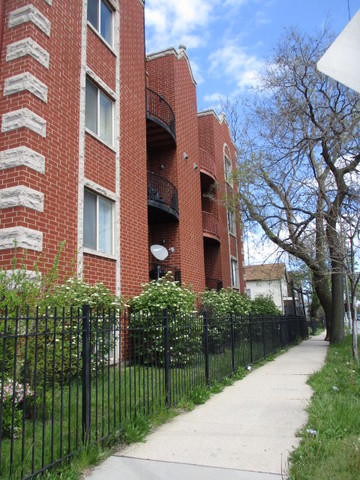 6655 South Perry Avenue, Unit 2C Chicago, IL 60621 - Photo 2 of 10 a view of a brick building next to a yard