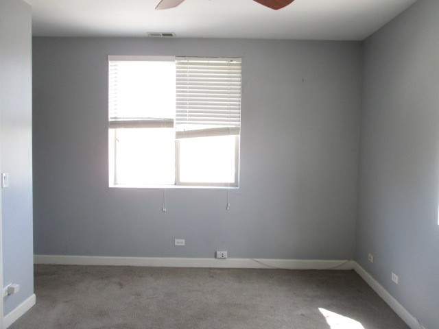 6655 South Perry Avenue, Unit 2C Chicago, IL 60621 - Photo 6 of 10 an empty room with a window