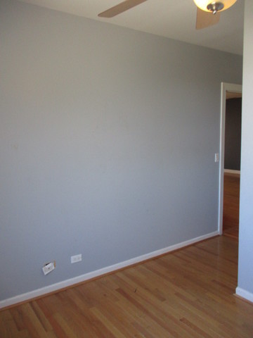 6655 South Perry Avenue, Unit 2C Chicago, IL 60621 - Photo 9 of 10 a view of an empty room with wooden floor