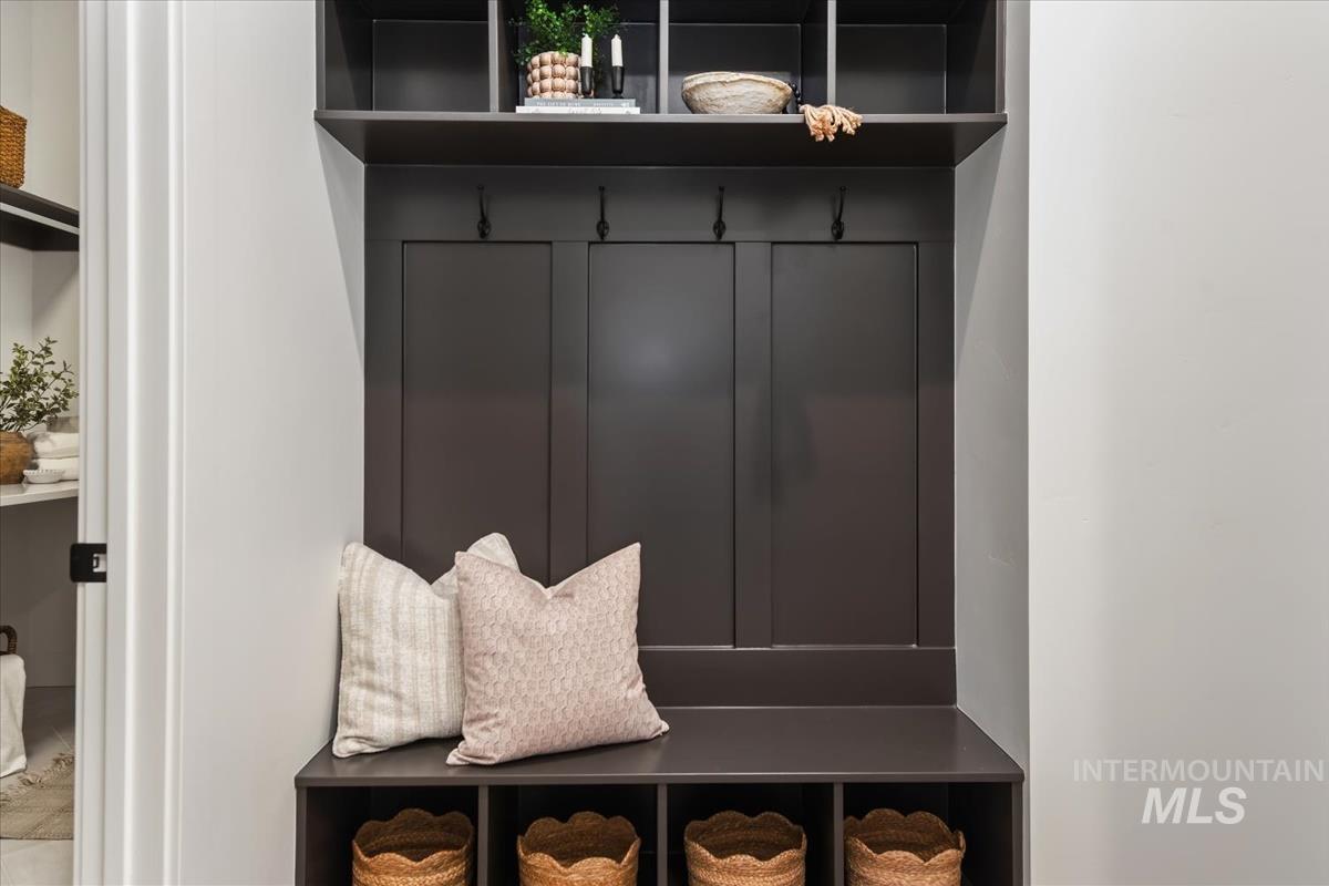 7615 Brown Way Eagle, ID 83714 - Photo 37 of 43 Built-in entryway storage unit featuring a dark wood finish, integrated bench seating, and upper shelving