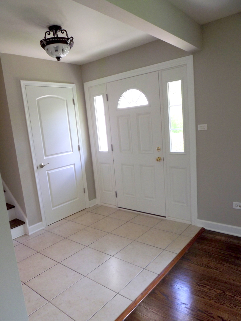18056 Perth Avenue Homewood, IL 60430 - Photo 12 of 42 an empty room with wooden floor and mirror
