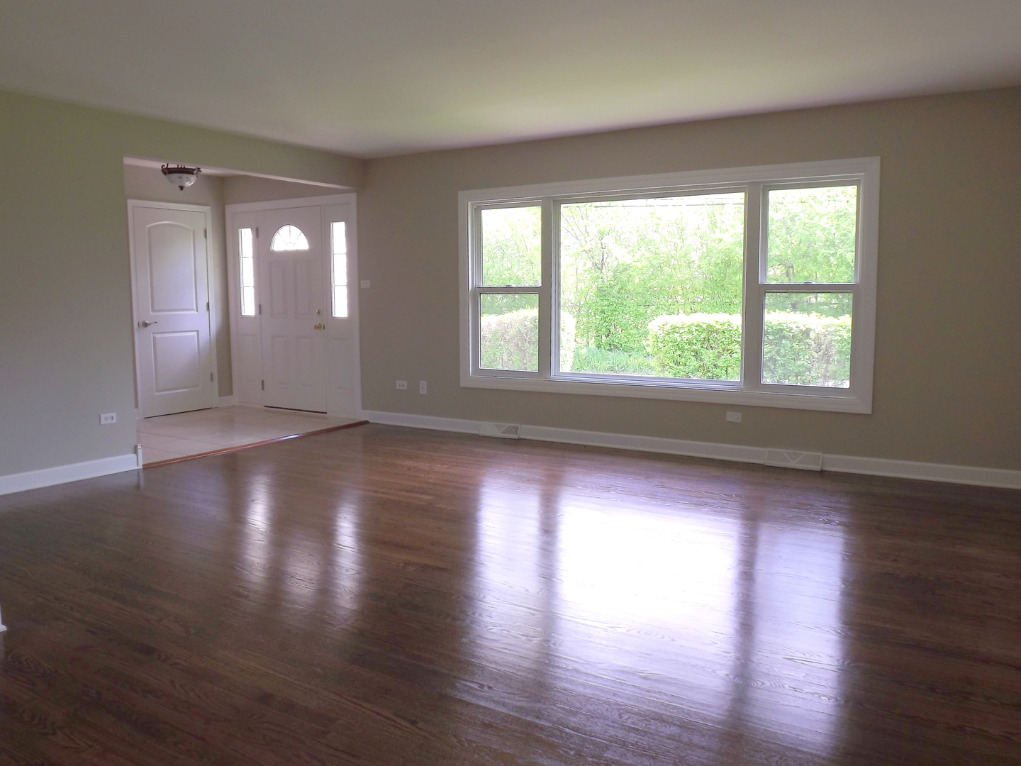 18056 Perth Avenue Homewood, IL 60430 - Photo 17 of 42 a view of an empty room with wooden floor and a window