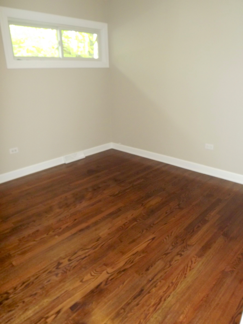 18056 Perth Avenue Homewood, IL 60430 - Photo 33 of 42 a view of an empty room with wooden floor and a window