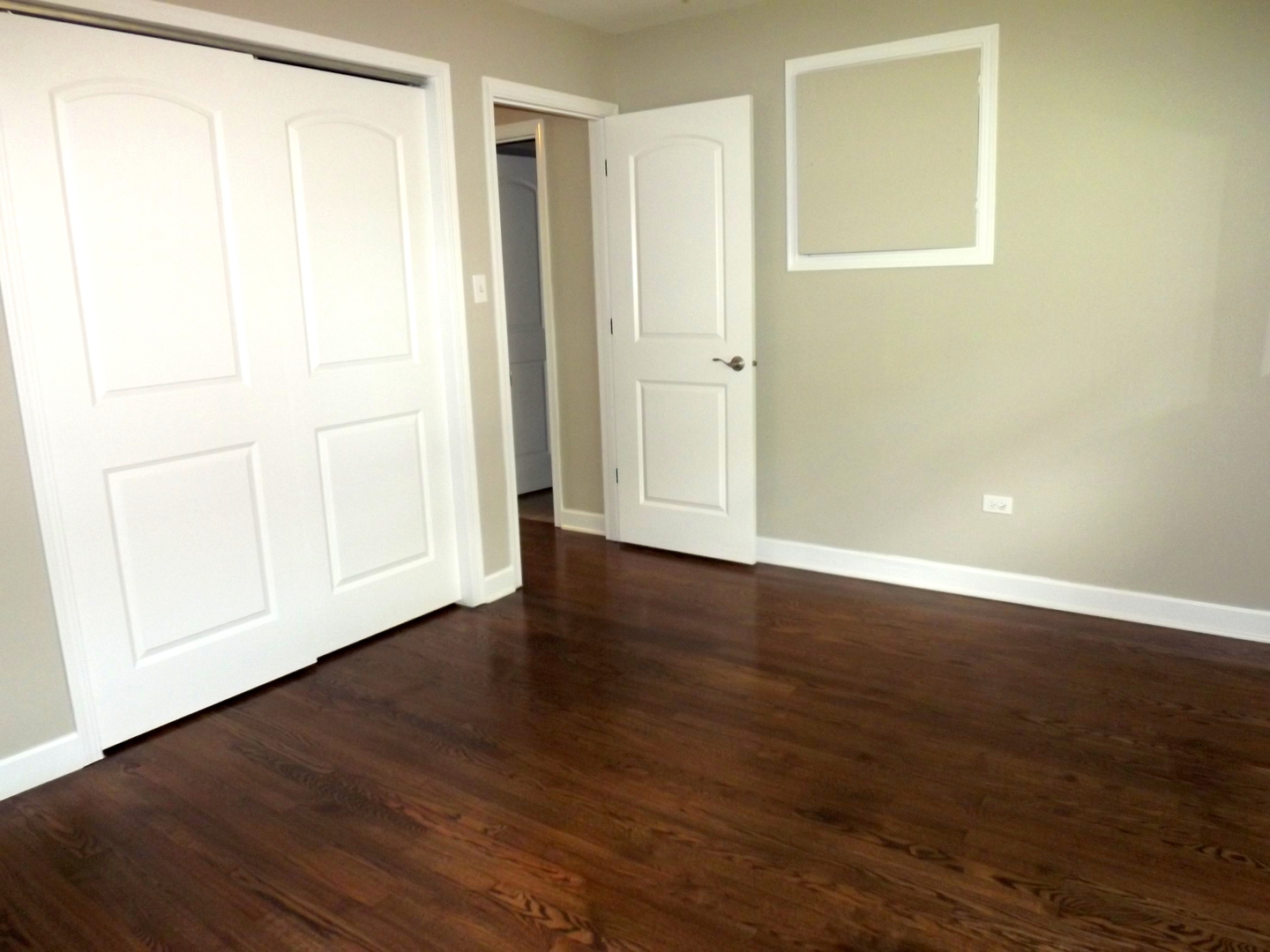 18056 Perth Avenue Homewood, IL 60430 - Photo 34 of 42 an empty room with wooden floor and closet area