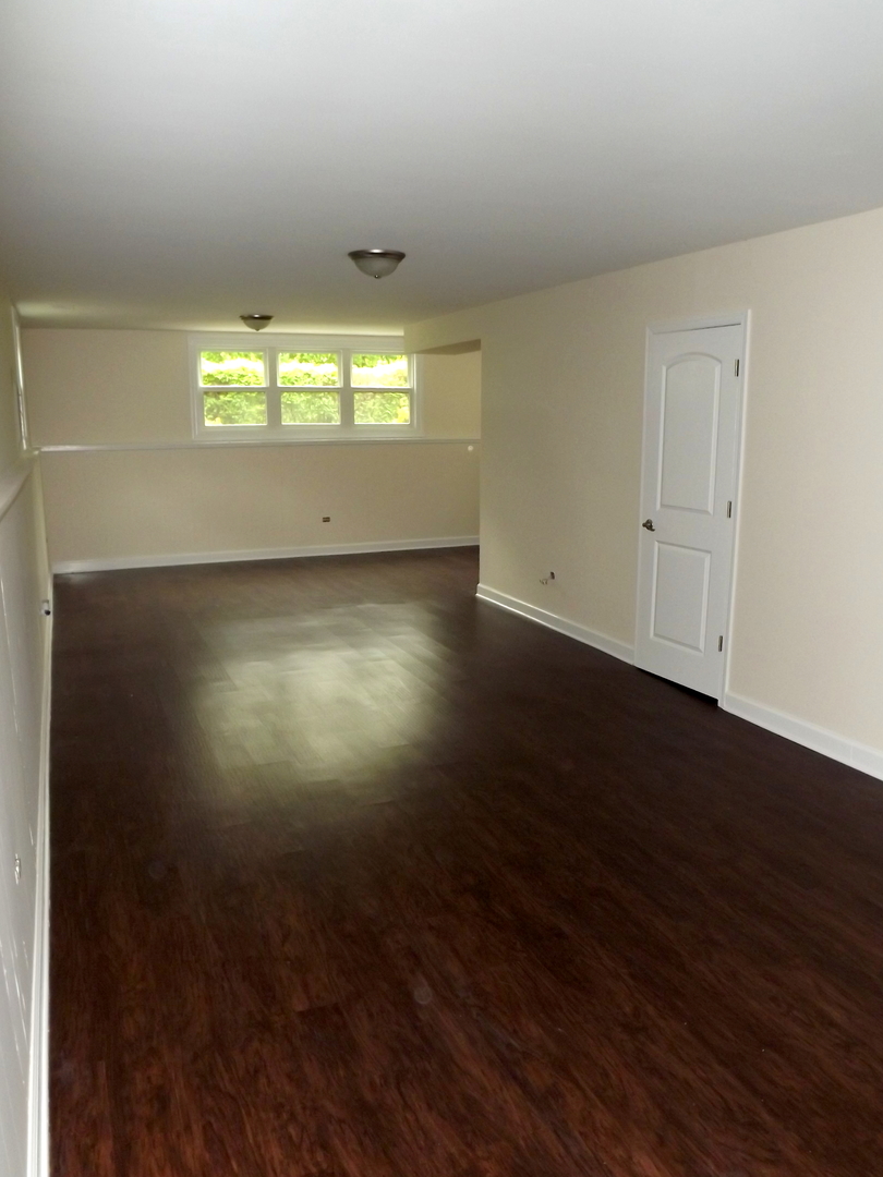 18056 Perth Avenue Homewood, IL 60430 - Photo 36 of 42 an empty room with wooden floor and windows