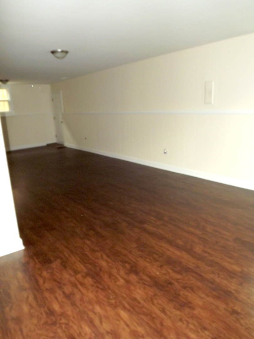 18056 Perth Avenue Homewood, IL 60430 - Photo 39 of 42 an empty room with wooden floor