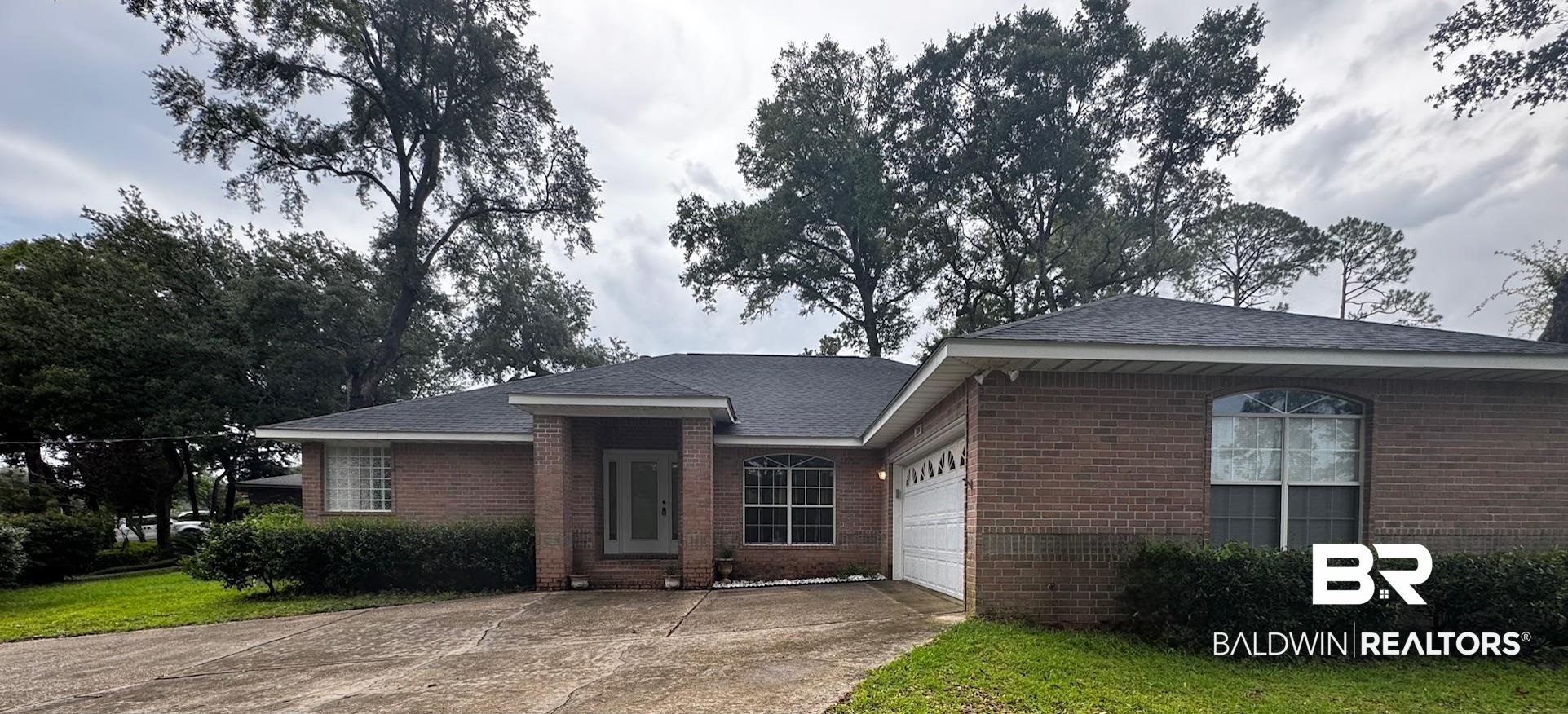 2204 Club House Drive Lillian, AL 36549 - Photo 3 of 38 Single story home featuring brick siding, concrete driveway, and a garage