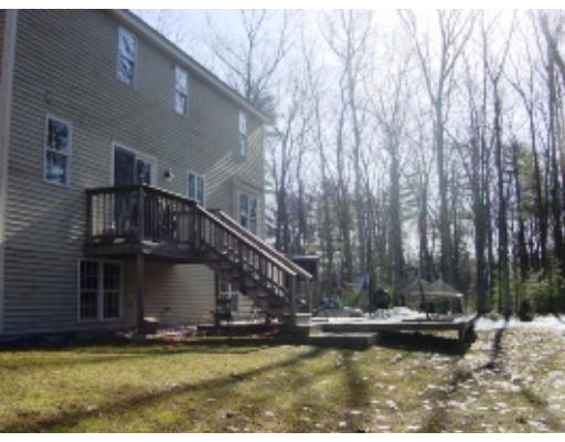 55 Rigby Road Lancaster, MA 01523 - Photo 3 of 8 a view of a house with pool and trees in the background