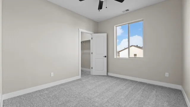 an empty room with windows and cabinet