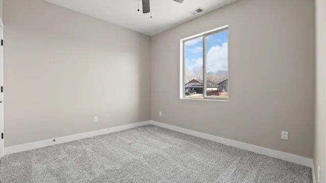 an empty room with windows and closet