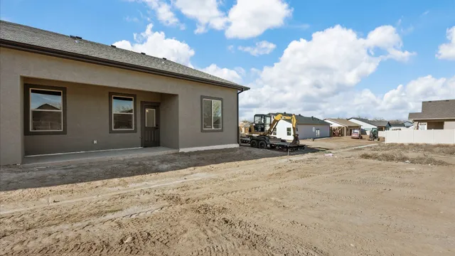 a view of a house with car parked on the road