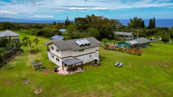 an aerial view of a house with a garden