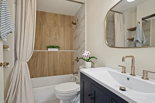 a bathroom with a sink a toilet and a tub