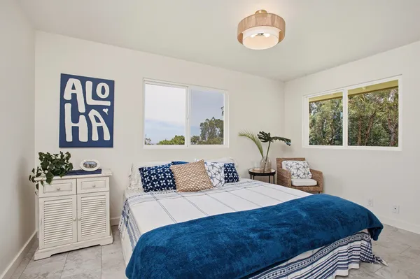a bedroom with a large bed and a window