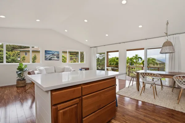 a kitchen with a table chairs and wooden floor