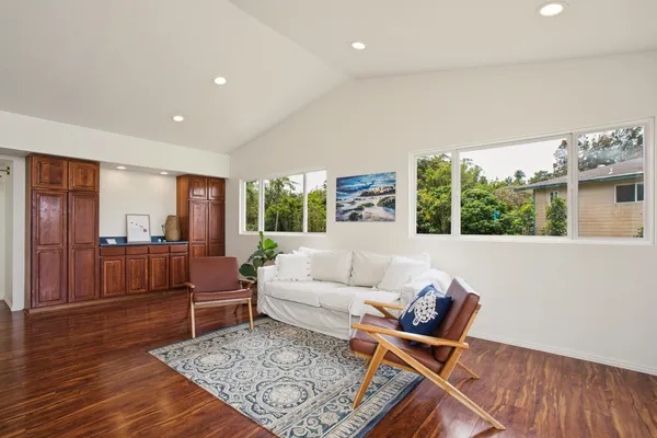 a living room with furniture rug and wooden floor