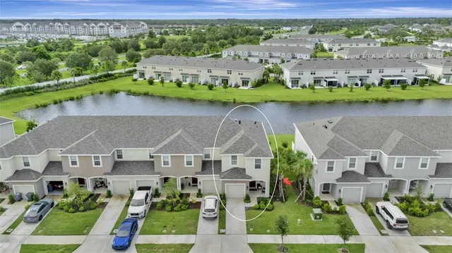 an aerial view of multiple houses with a yard