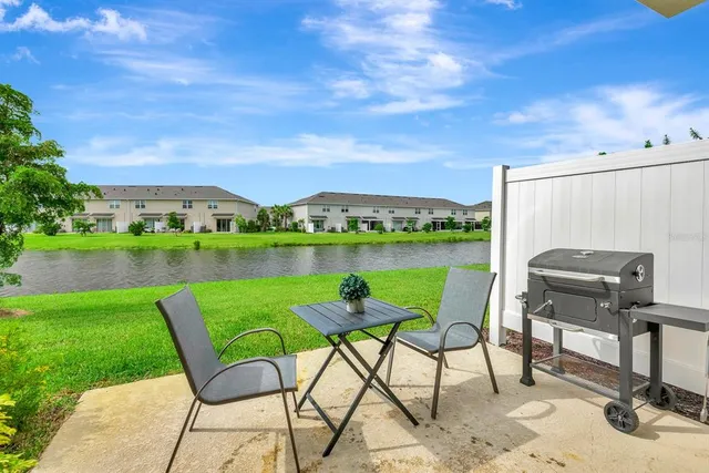 a patio with water view fountain and a table