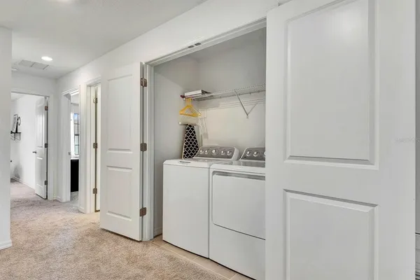a bedroom with a bed and a potted plant
