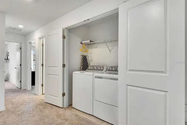 a bedroom with a bed and a potted plant