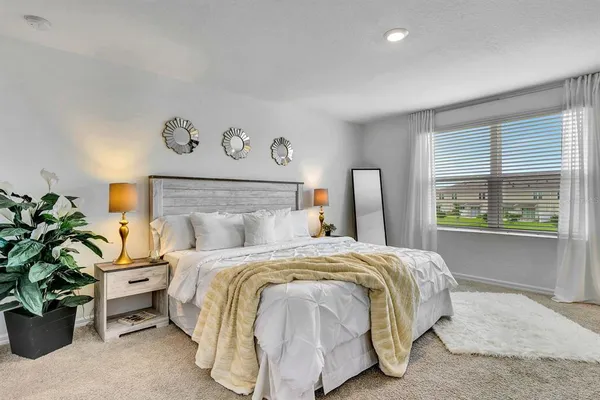 a bedroom with a bed and a dresser