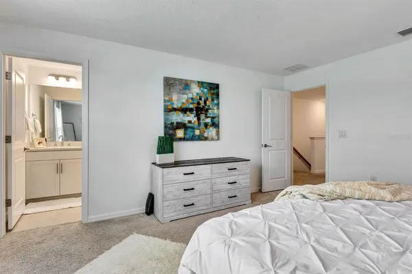 a bedroom with a bed and a mirror