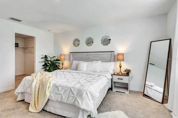 a bedroom with a bed and a window