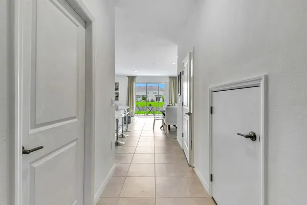 a view of a hallway view of three rooms