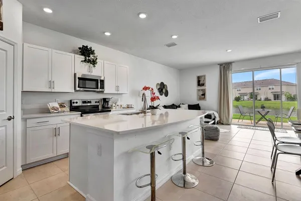 a kitchen with stainless steel appliances kitchen island granite countertop a sink and cabinets