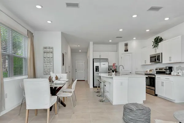 a kitchen with stainless steel appliances kitchen island granite countertop a sink and cabinets