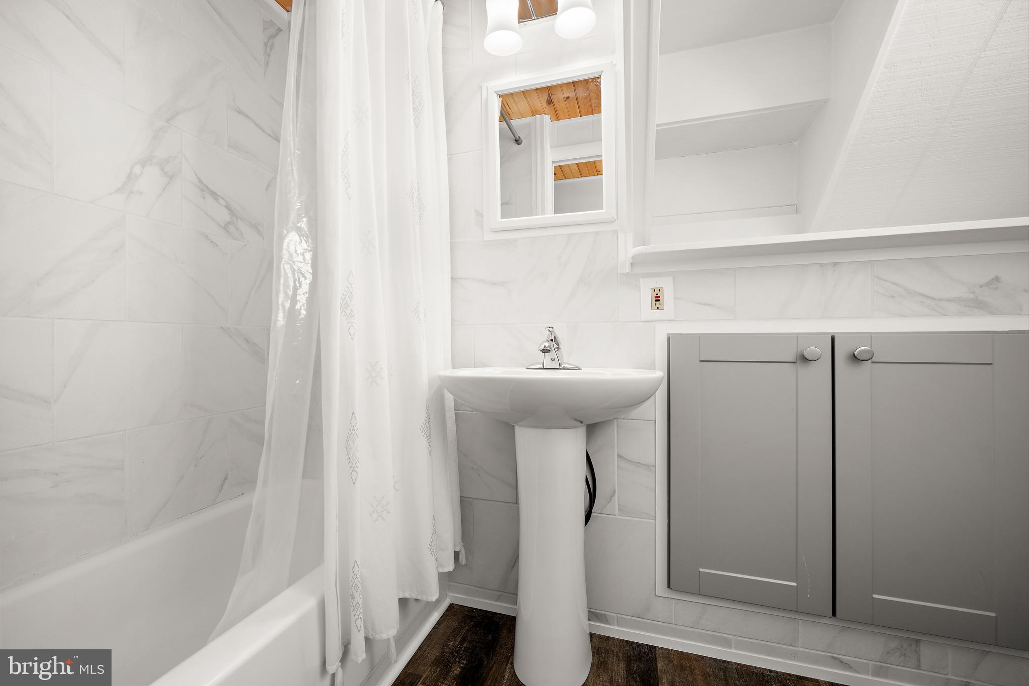 8 Virginia Avenue Milton, DE 19968 - Photo 15 of 50 a bathroom with a sink a mirror and a shower