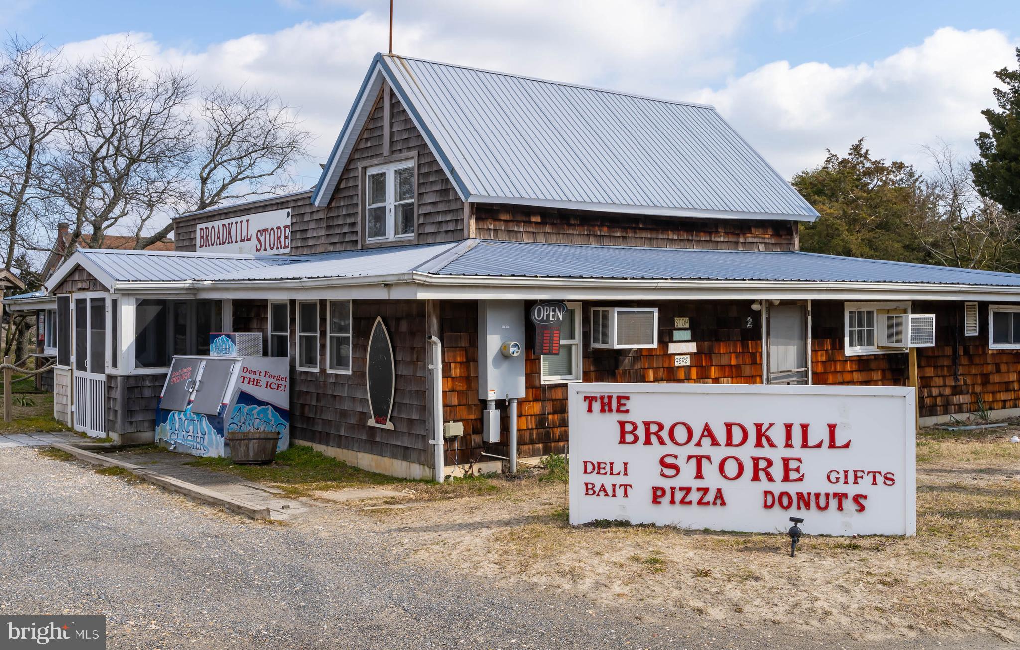 8 Virginia Avenue Milton, DE 19968 - Photo 49 of 50 a front view of a building with retail shops
