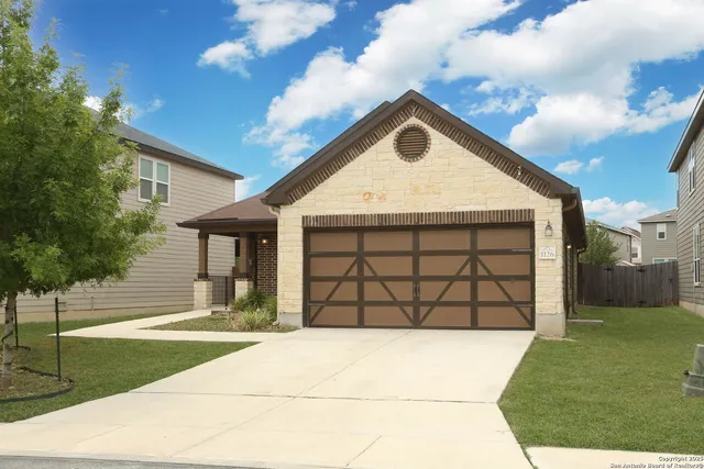 a view of a wooden house with a yard