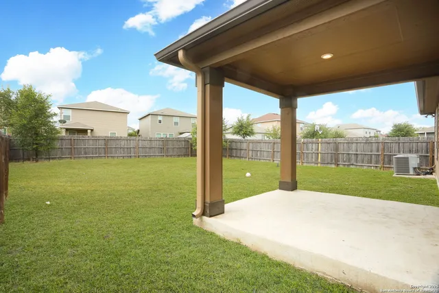a view of green field with house in the background