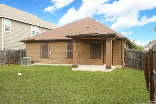 a front view of a house with a garden and yard