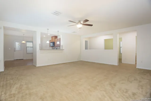 a view of a big room with closet and windows