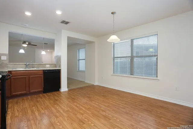 a large kitchen with kitchen island a counter space a sink stainless steel appliances and cabinets