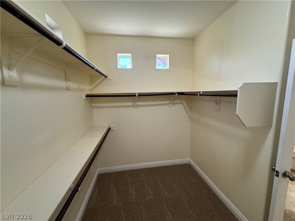 1333 Jamesbury Road Las Vegas, NV 89135 - Photo 37 of 43 Ample shelving and hanging space define this functional walk-in closet, complete with high windows for natural light.